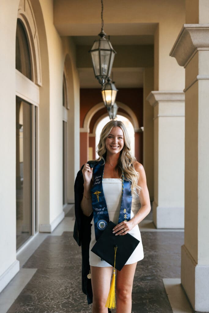 woman posing for grad photos at lake las vegas