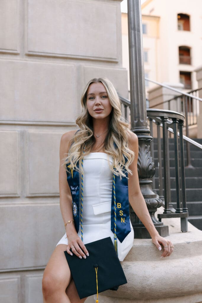 woman sitting posing for grad photos at lake las vegas