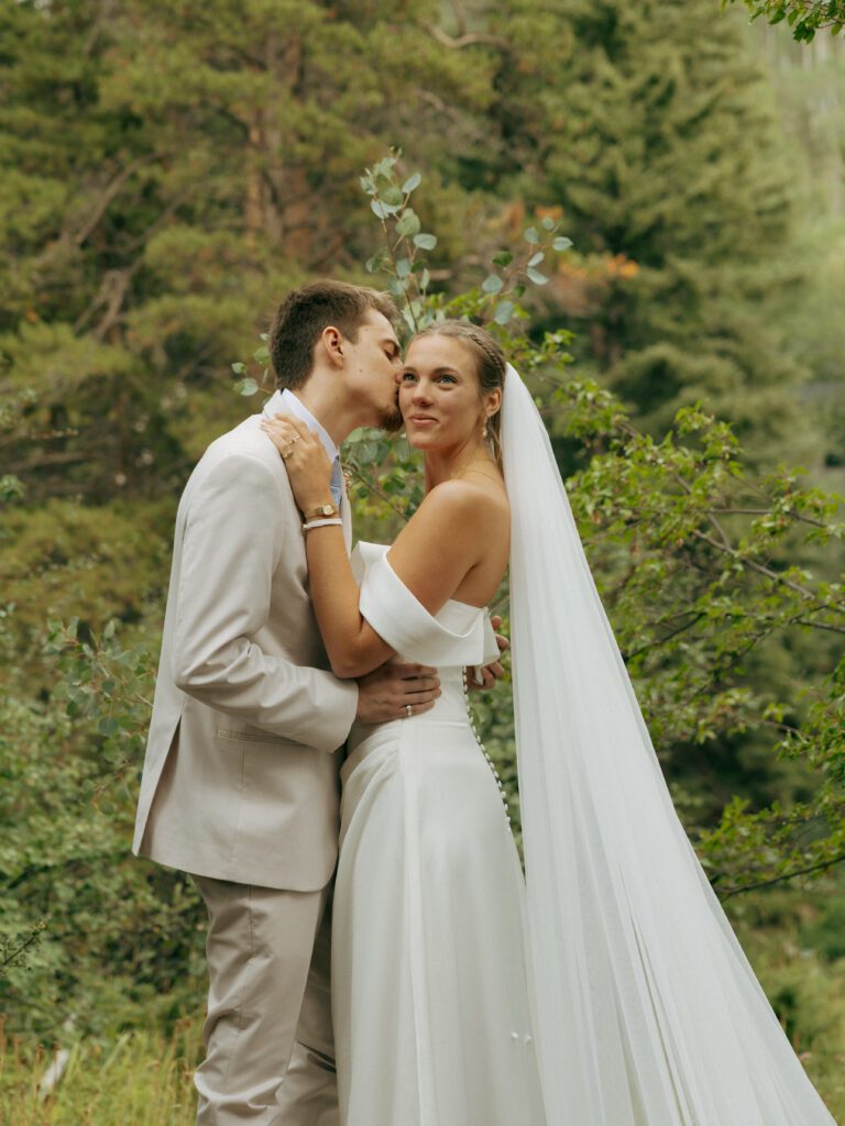 groom kissing the brides cheek