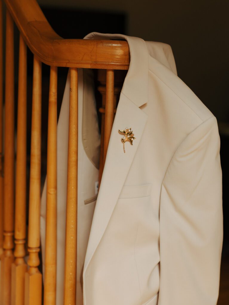 grooms jacket hanging on the stair railing