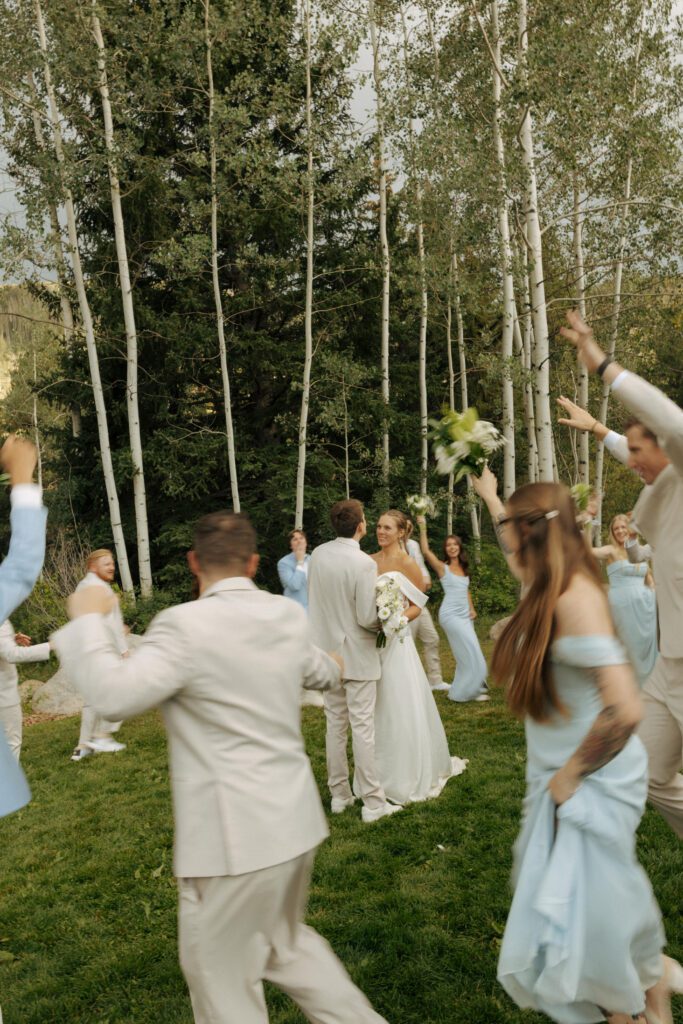 wedding party dancing around bride and groom