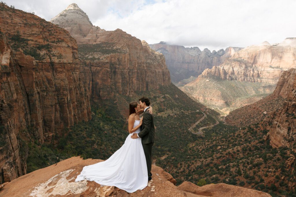 bride and groom kissing at the zion national park overlook