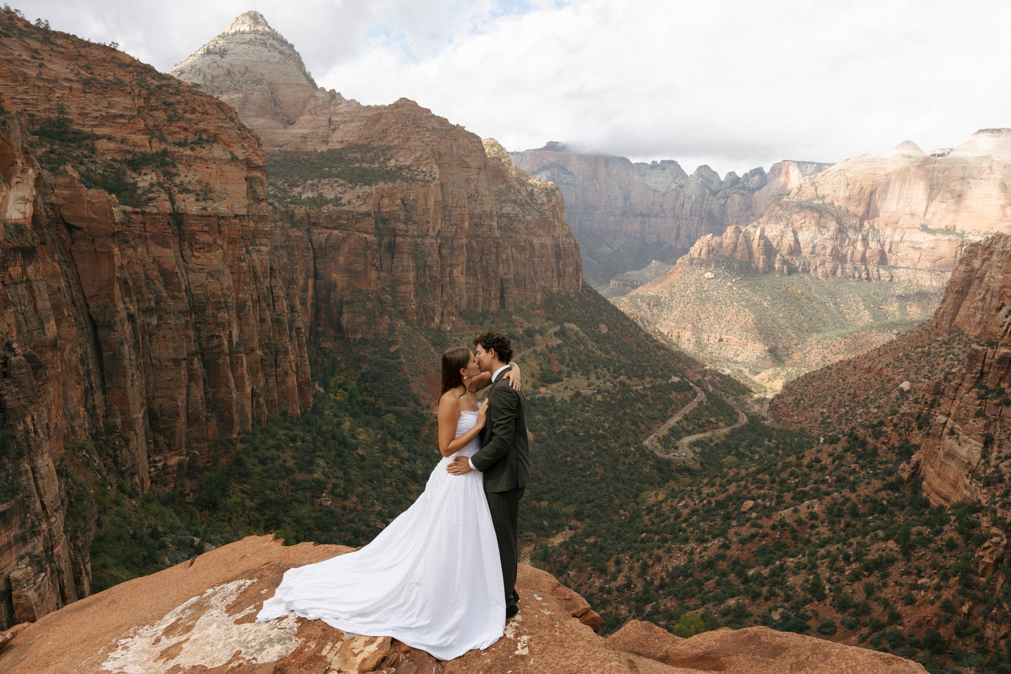 bride and groom kissing at the zion national park overlook