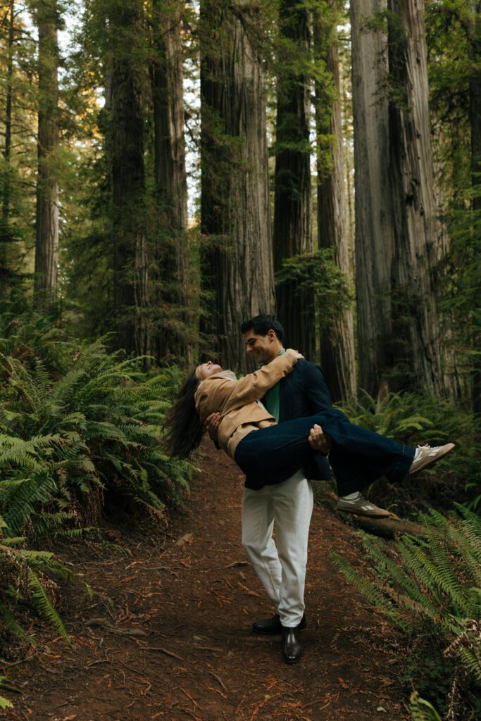 couple playing in the redwood national forest