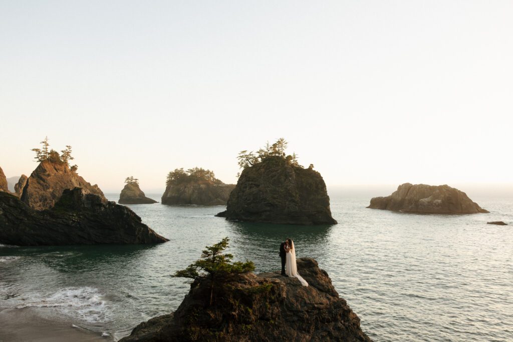 elope at secret beach in oregon couple sharing first kiss